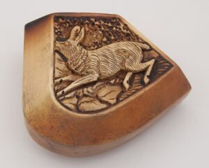 Intricate carving of running hare on one side and castle on another left side - Decorative Woodcarving