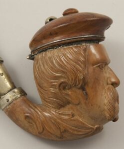 Long stemmed pipe with bowl in the shape of head of a man with a captain's hat closeup side - Decorative Woodcarving