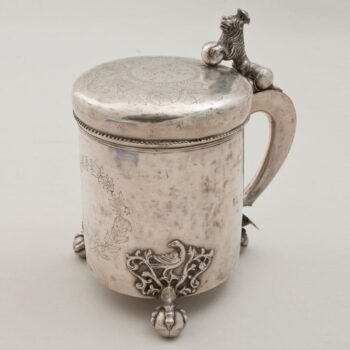 Tankard with three claw-and-ball feet above which are cast acanthus motifs with a bird in the center - Norwegian Metalworking