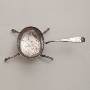 Strainer with perforations in the shape of flower petals in the bottom of the bowl - Norwegian Metalworking