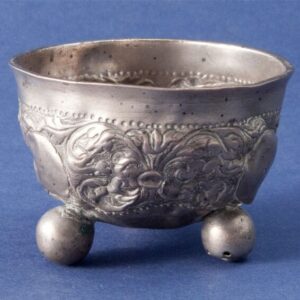 Wine cup with three hollow ball feet and repoussé and chased floral design - Norwegian Metalworking