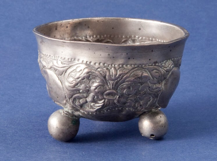 Wine cup with three hollow ball feet and repoussé and chased floral design - Norwegian Metalworking