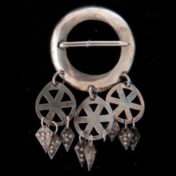 Brooch with narrow circular band that is crossed by a pin - Norwegian Metalworking