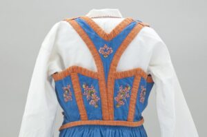 Dress with blue vest, a v-back, and orange trim - Textiles