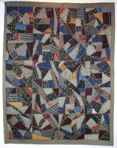 Crazy quilt is made of primarily dark cotton prints - Textiles