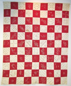 This friendship quilt is made of solid red and white square blocks assembled in a checkerboard fashion - Textiles