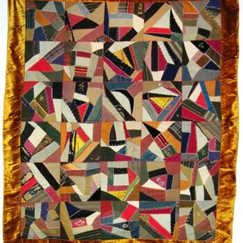 Quilt with seams between the pieces are decorated with a large variety of multicolored stitches