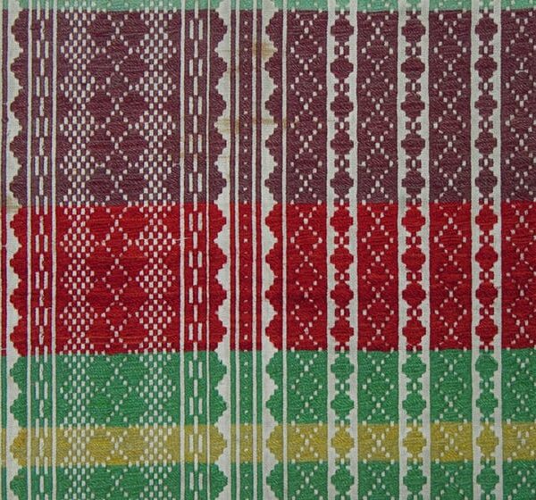 Coverlet with pattern wool in vertical bands of diamond forms on red, orange, yellow, pastel green and mauve horizontal bands - Textiles