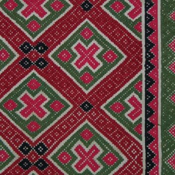 Coverlet with pattern in two-ply wool of diamonds and related geometric forms in two shades of red, green, and dark blue - Textiles