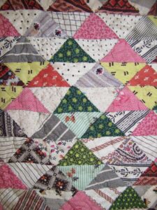 Nineteenth century calico baby quilt is made of 1.5 x 2 inch triangles - Textiles