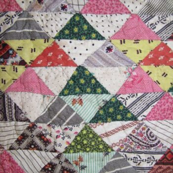Nineteenth century calico baby quilt is made of 1.5 x 2 inch triangles - Textiles