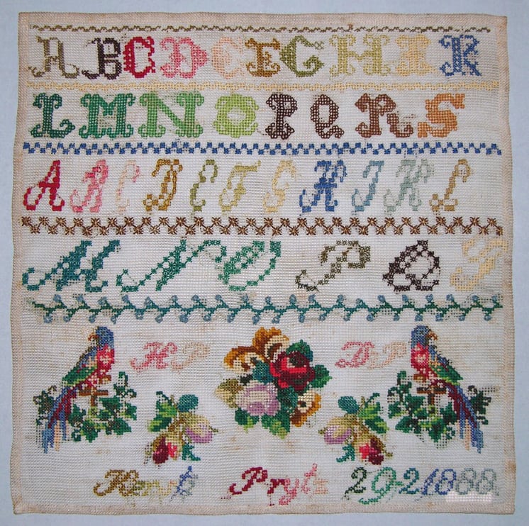 Sampler (navneduk) with floral designs, two birds, initials, and letters of the alphabet