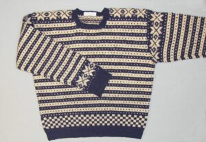 Hand-knit, Fana-style, sweater has dark blue and white lateral bands with contrasting "lice" or colored dots - Textiles