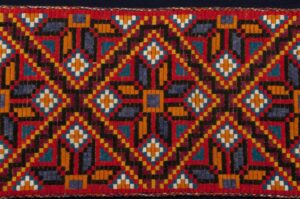 Table runner with a geometric star design in a weave which resembles klostersaum - Textiles