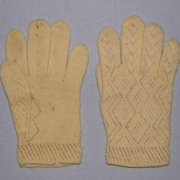 Gloves with knit lace patterns on the backs, along thumbs, and around the wrists - Textiles