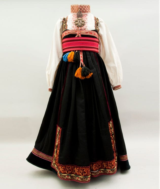 This bunad has a floor-length heavily gathered skirt that joins to a brocaded silk bodice above the bust - Textiles