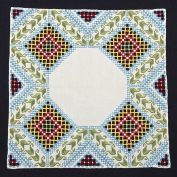 Doily with Hardanger embroidery in green, red, yellow, and blue - Textiles