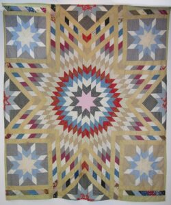 Pieced quilt top is done in the blazing star - Textiles