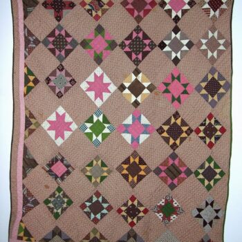 Quilt constructed with blocks of eight-pointed stars