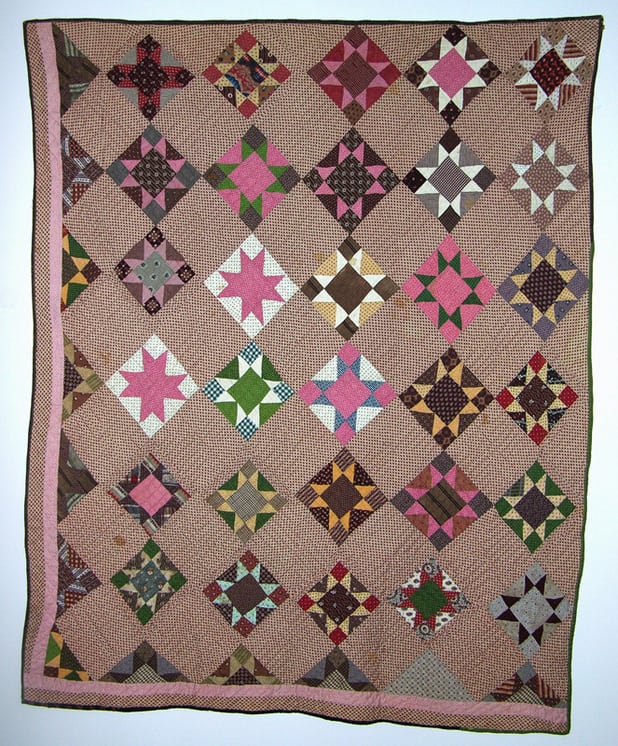 Quilt constructed with blocks of eight-pointed stars
