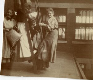 Four women pose for a photograph outside of a building.
