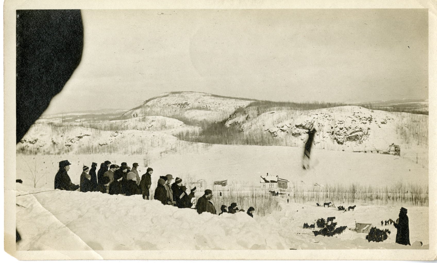 People gather to watch a skier jump.