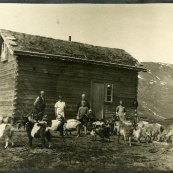Six members of the Medhus family outside of home with goats.
