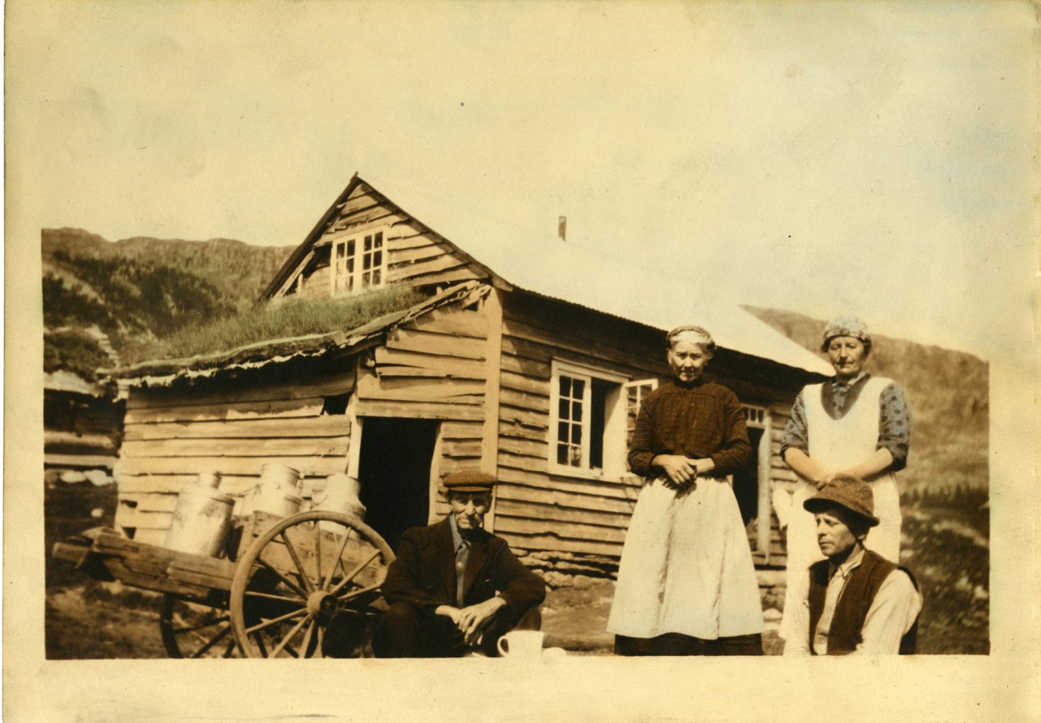 Two women and two men pose for photo outside of house.