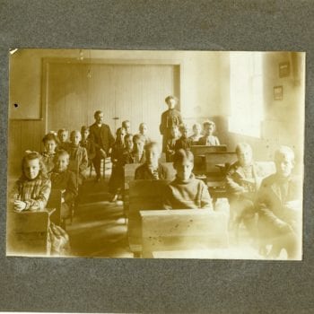 Eighteen children and three adults in a classroom.