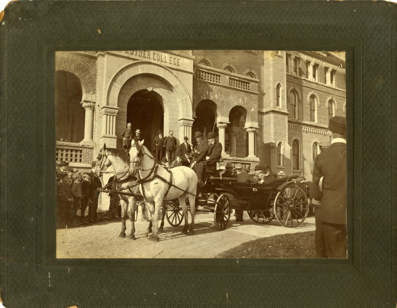 Men outside of Luther's Main Building with horse and buggy.