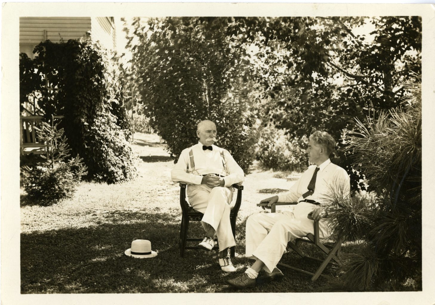 Two men sit outside together.