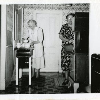 Two women work in the kitchen.