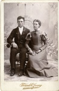 Man and woman pose in a studio.