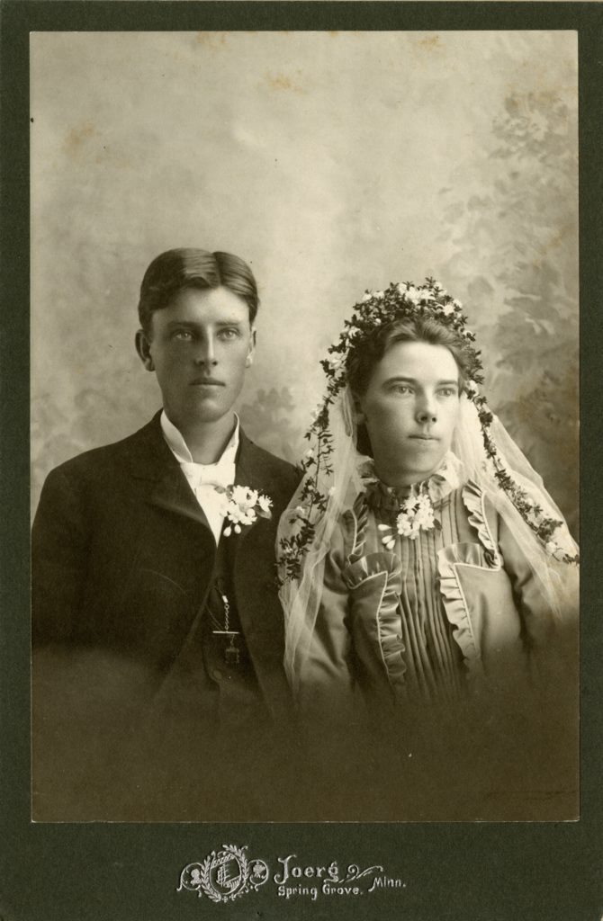 Man and woman pose in a studio.