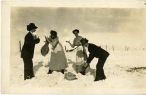 Four girls throw snow.